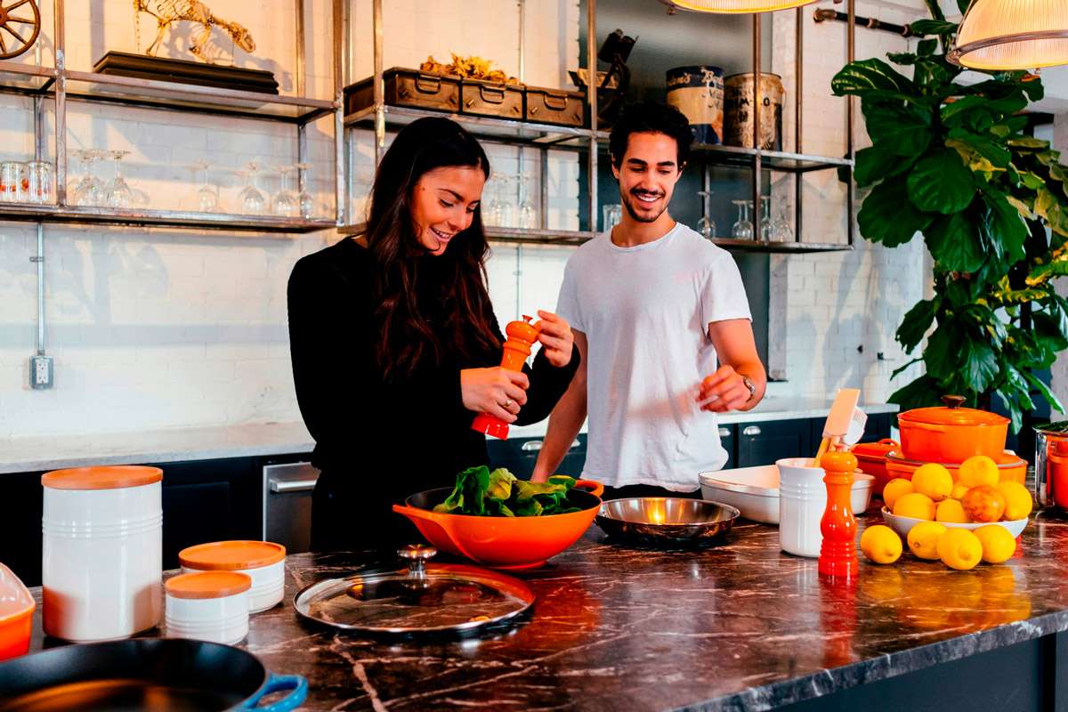 Happy couple working together in the kitchen, preparing a meal. Author Jason Briscoe